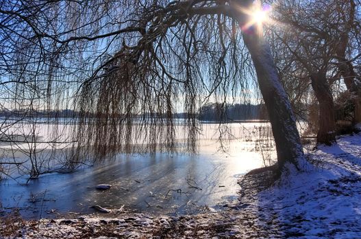 Snow covered frozen lake landscape in northern europe on a sunny day