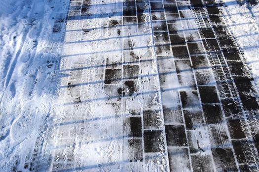 Tire Tracks on snow covered streets in a close up view