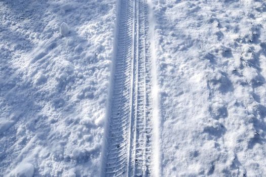 Tire Tracks on snow covered streets in a close up view