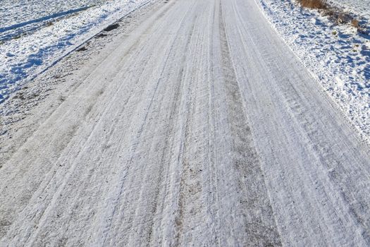 Tire Tracks on snow covered streets in a close up view