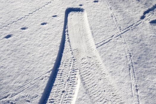 Tire Tracks on snow covered streets in a close up view