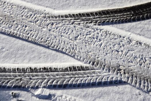 Tire Tracks on snow covered streets in a close up view