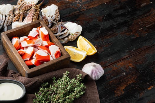 Asian snack surimi set, in wooden box, on dark wooden background , with copyspace and space for text