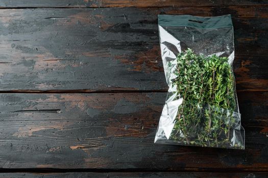 Fresh juicy Thyme in market pack set, on dark wooden background , with copyspace and space for text