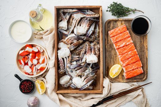 Fresh Crab meat and sticks surimi with blue swimming crab set, on white background, top view flat lay