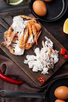 Ingredients for breakfast omelette with crab meat and cheese set, on dark wooden background, top view flat lay