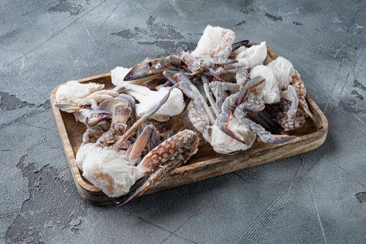 Horse crab, Blue crab, Flower crab frozen in ice set, on wooden tray, on gray background