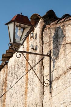 Old broken rustic village lamppost