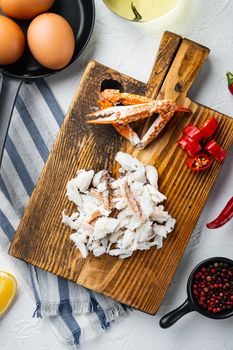 Spanish or Thai omelette ingredient, fresh red chilli, brown and white crabmeat, lemon, Cheddar cheese, eggs set, on white background, top view flat lay