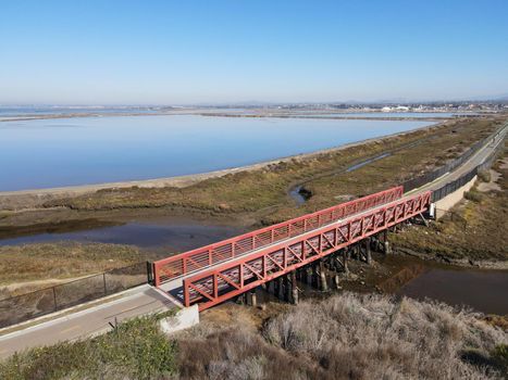 Aerial view of Small bridge on Otay River next to San Diego Bay National Refuger in Imperial Beach, San Diego, California, USA