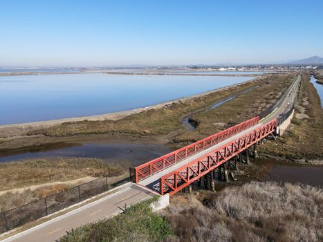 Aerial view of Small bridge on Otay River next to San Diego Bay National Refuger in Imperial Beach, San Diego, California, USA