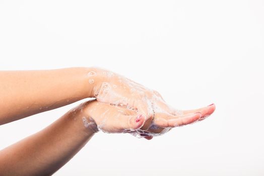 Closeup young Asian woman washing hands by soap for cleanliness and prevent germs coronavirus, studio shot isolated on white background, Healthcare medical COVID-19 virus concept