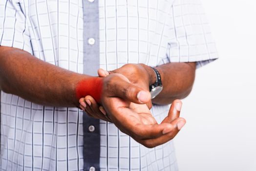 Closeup hand Asian black man holds his wrist hand injury, feeling pain, studio shot isolated on white background. Health care and medical office syndrome concept