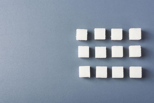 White sugar cube sweet food ingredient geometry pattern, studio shot isolated on a gray background, Minimal health high blood risk of diabetes and calorie intake concept