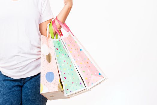 Happy woman hand holding shopping bags multicolor, young female hold many packets within arms isolated on white background, Black friday sale concept