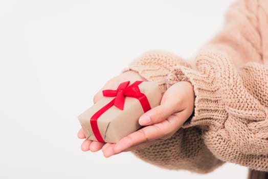 Valentine's Day. Woman beauty hands holding small gift package box present wrapped paper with ribbon isolated on white background, Birthday, New year, Christmas, holiday background concept