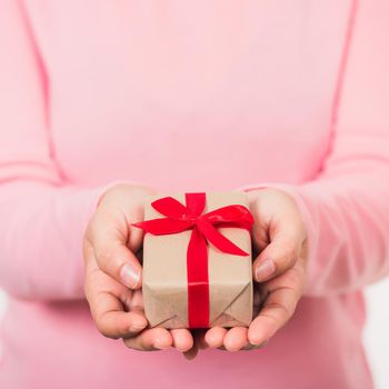 Valentine's Day. Woman beauty hands holding small gift package box present wrapped paper with ribbon isolated on white background, Birthday, New year, Christmas, holiday background concept