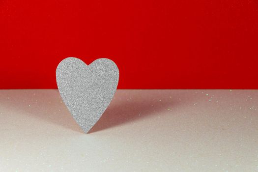 Saint Valentine's day silver heart on textured white with red background