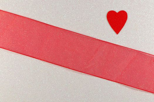 Saint Valentine's day red heart and broad red ribbon design on textured white background