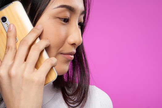 pretty asian woman talking on the phone technology close-up. High quality photo
