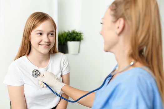 woman doctor examining a child stethoscope hospital. High quality photo