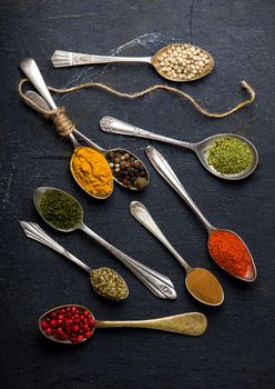 Various spices spoons on table. Top view with copy space