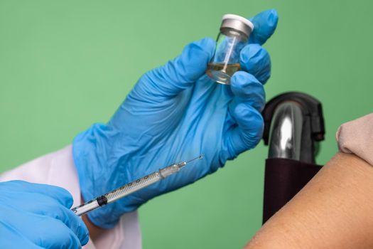 Chroma key, nurse doing vaccine injection to senior woman.