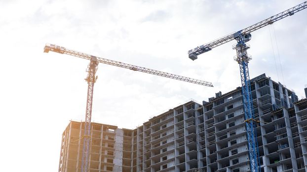 Construction site with Construction crane and cloudy sky on background