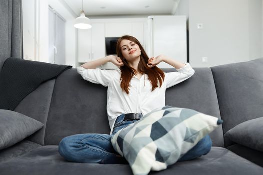 woman with pillow in comfortable sofa at home interior. High quality photo