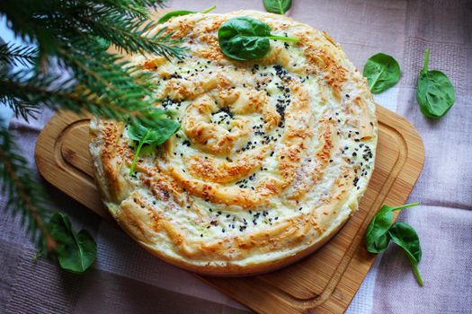 Meat pie with a crispy crust and decorated with herbs.Texture or background.Texture or background