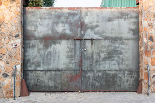 Old door of an abandoned factory in southern Spain, with a nice patina