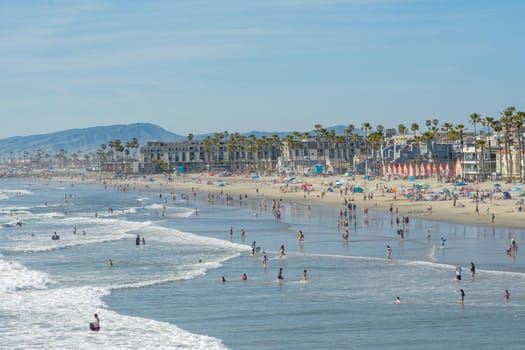 People on the beach enjoying beautiful summer day at Oceanside beach in San Diego, California. 