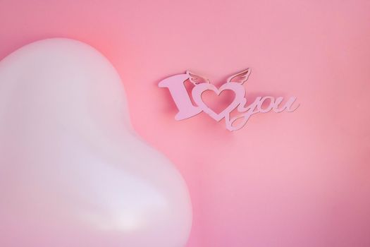 Pink balloon in the shape of a heart on a pink background, with a sign I love you. Wedding concept, Valentine's Day, photo zone, lovers. Banner. top view. Place for your text