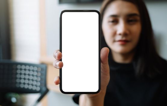Woman show smartphone with blank white screen.