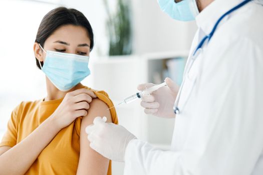 woman wearing a medical mask at the doctor's appointment covid-19 vaccination epidemic. High quality photo