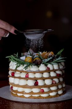 Hands of young woman holding birthday cake selective focus.