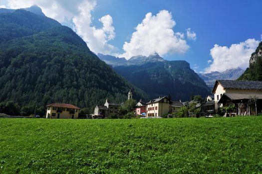 View on the municipality of Sonogno over a green meadow