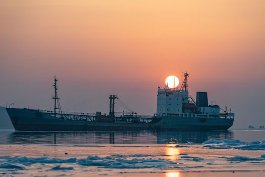 Seascape with fishing boat on sunset background. Vladivostok, Primorsky Krai.
