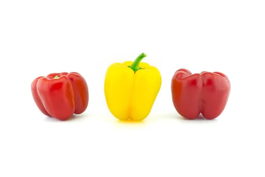 Three red and yellow bell peppers isolated on white background