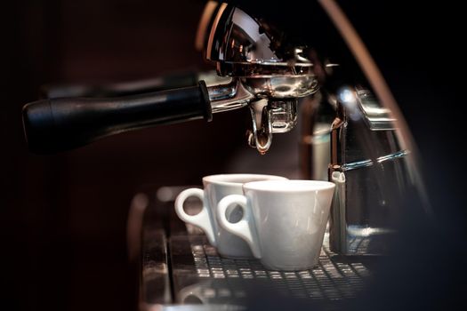 preparing double espresso coffee on a professional machine.