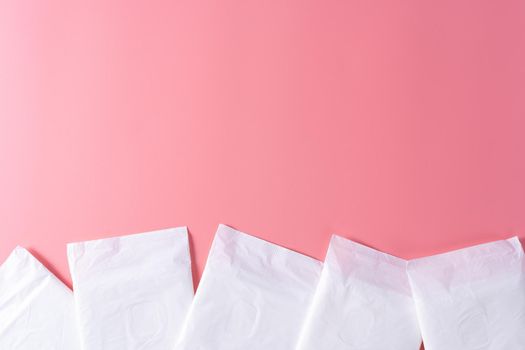 Sanitary pad, Sanitary napkin on pink background. Menstruation, Feminine hygiene, top view.
