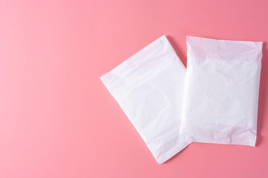 Sanitary pad, Sanitary napkin on pink background. Menstruation, Feminine hygiene, top view.