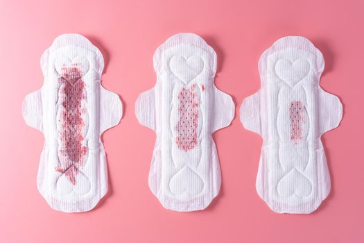 Set of different used sanitary pad, Sanitary napkin on pink background. Menstruation, Feminine hygiene, top view.