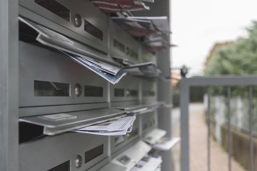 Modern mailboxes filled of flyers. Business and advertising concepts. Shallow depth of field.