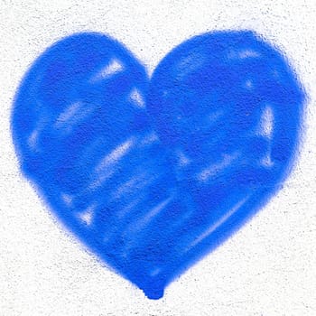 Blue heart on grungy wall. Creative spray paint. Ideal for Love and Valentine's Day concepts.