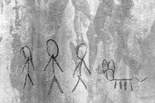 Family drawing on the rustic wall. Graffiti with a childlike trait.