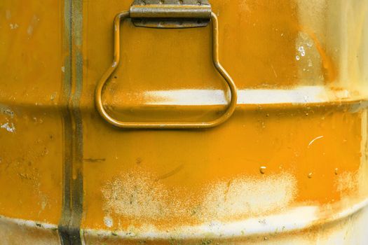 Orange color can. Metal can with orange paint drips.