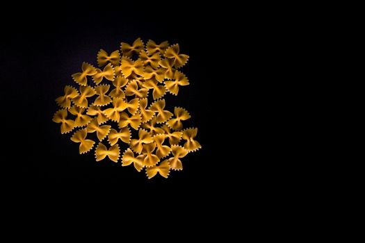 Heart made of farfalle pasta, dry pasta in a heart shape