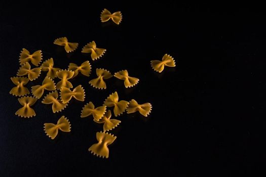 Close up of dry uncooked farfalle pasta isolated.