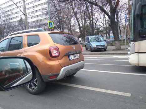 Road view through car window and mirror, cars on road in traffic in Bucharest, Romania, 2021